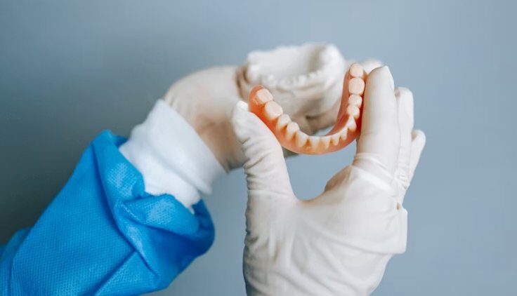 Partial denture in lab technician hands